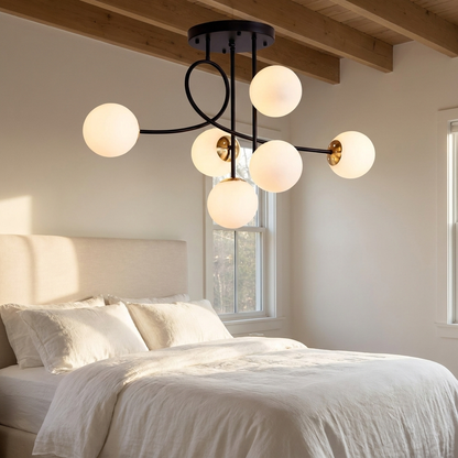 Lenore black chandelier with milk white globes in a calm bedroom