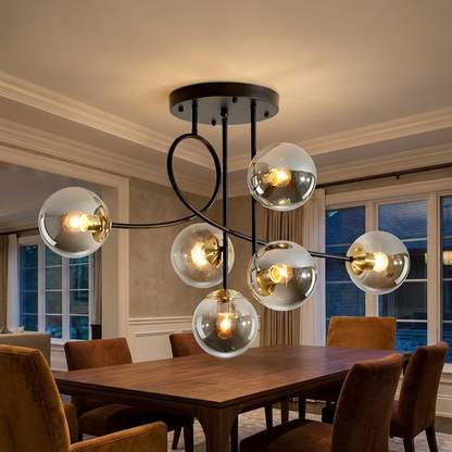 Lenore black chandelier with smoke grey globes above a walnut dining table