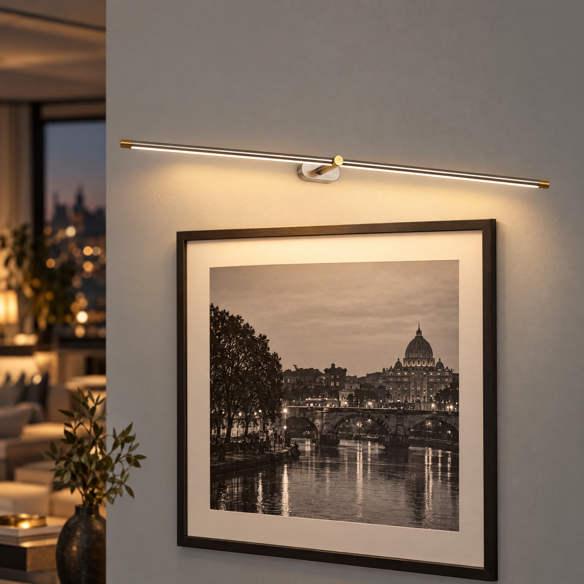 Kova Rechargeable Linear Wall Light in Nickel and Gold, close-up above a photograph
