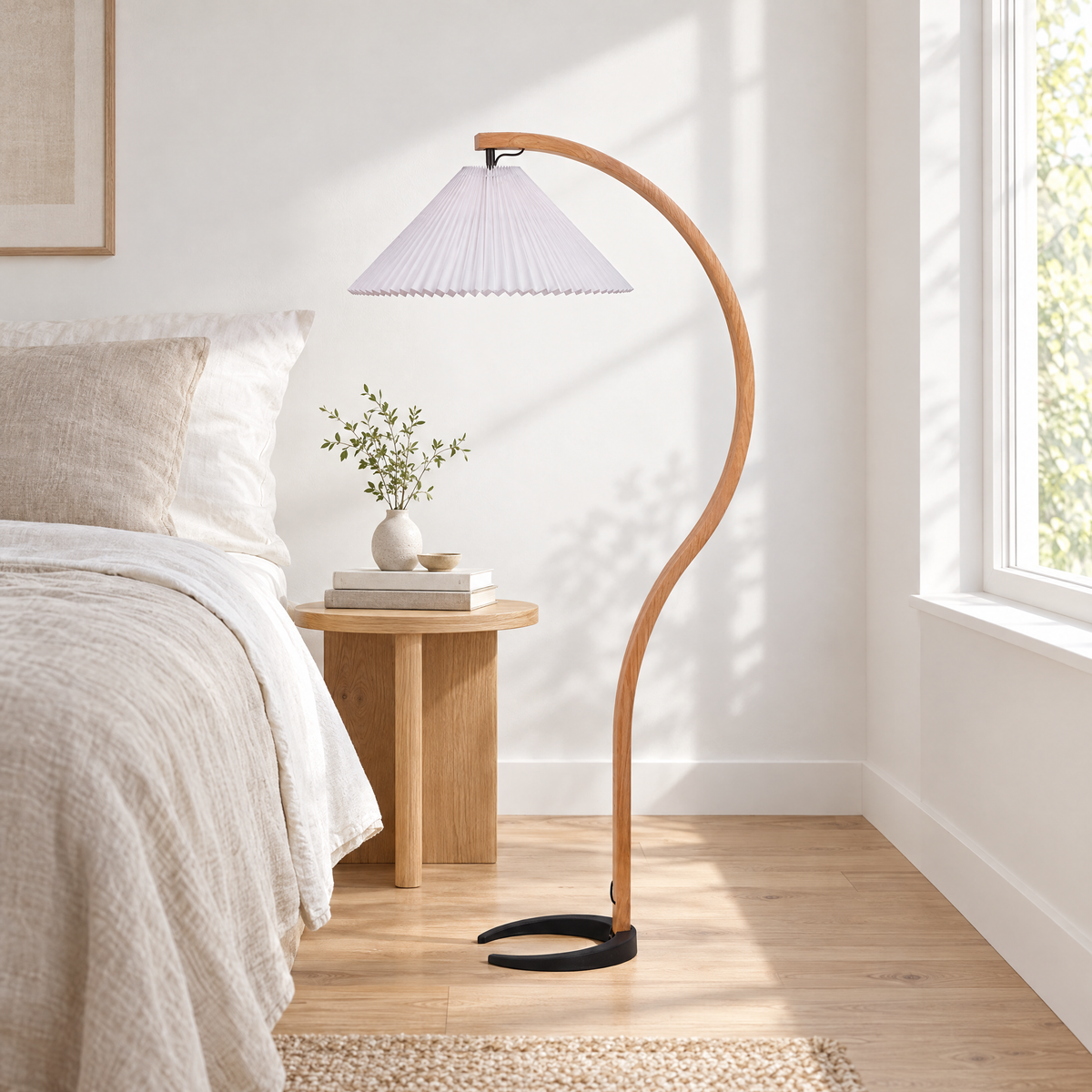 Caprani Beech Wood Linen Floor Lamp with White shade beside a bed