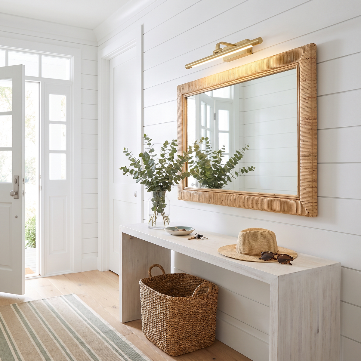 Brillan Model A gold LED picture light in a coastal entry hall