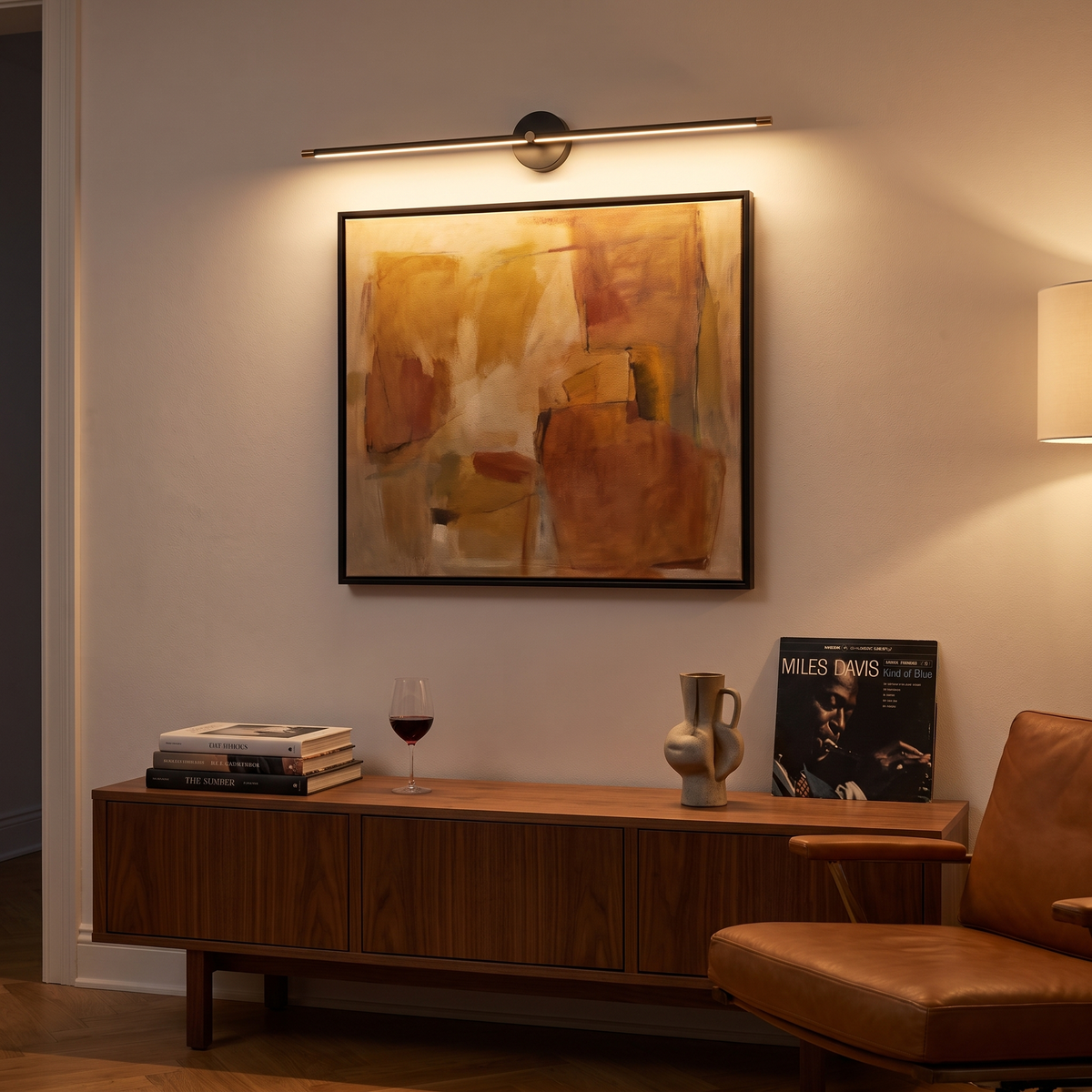 Arlen Black linear LED picture light above framed art in a mid-century living room