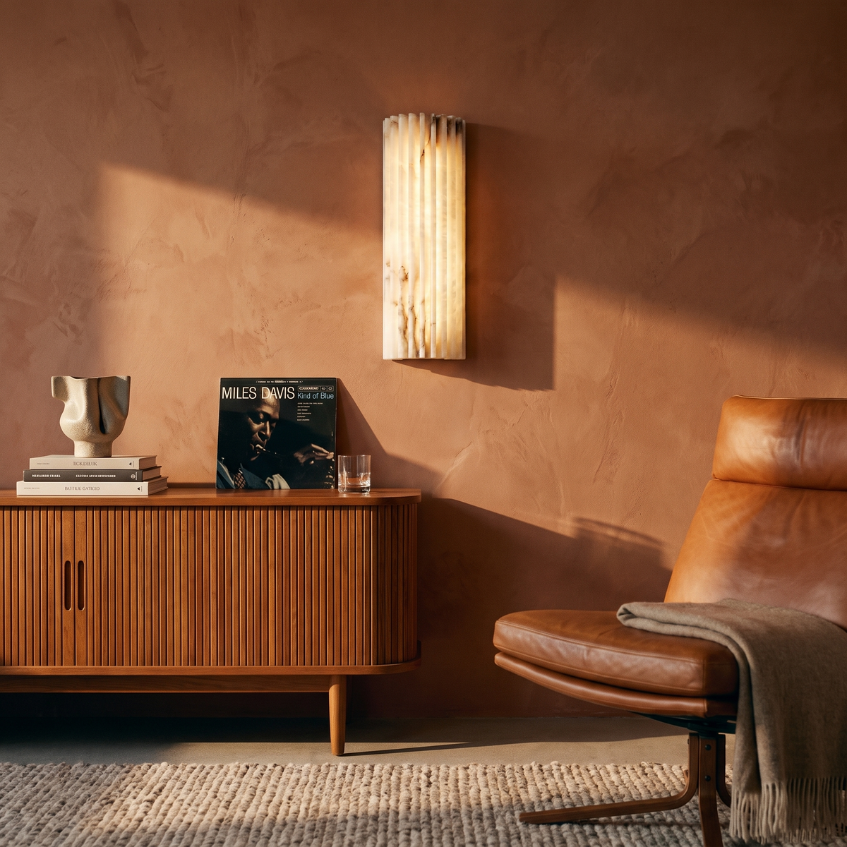 Alvia White alabaster wall sconce in a mid-century living room