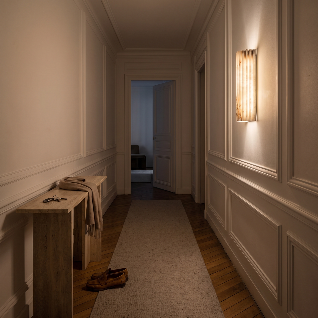Alvia White alabaster wall sconce in a panelled hallway
