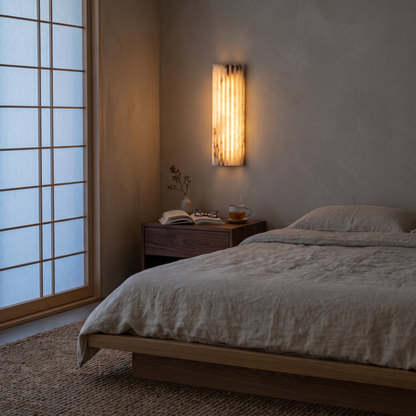 Alvia White alabaster wall sconce in a Japandi bedroom beside the bed
