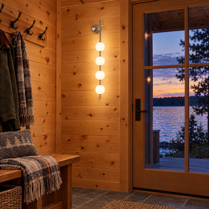Kaskade globe wall sconce in nickel with 5 small globes in a Minnesota lake house entryway