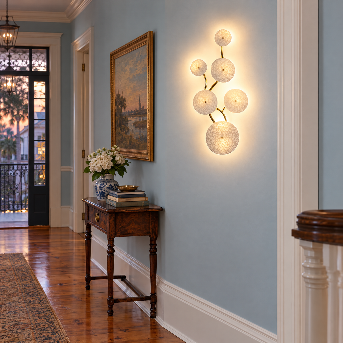 Florin ceramic petal wall sconce in white ceramic and gold, 6-petal vertical, in a Charleston single house hallway