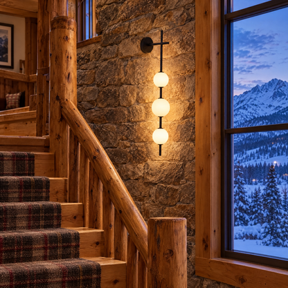 Kaskade globe wall sconce in black with 4 globes in a Colorado mountain lodge stairwell