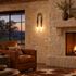 Palomino wall sconce in aged bronze & brown in a Texas Hill Country stone house living room