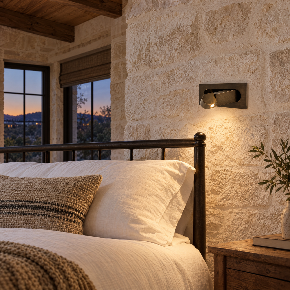 Lectra bedside reading wall light in bronze in a Texas Hill Country stone house guest room