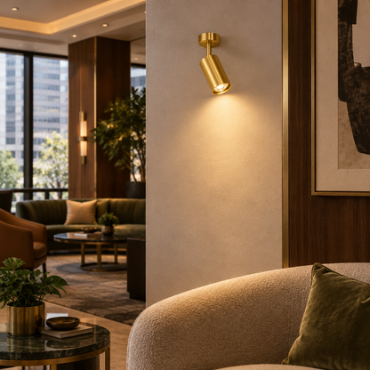 Ziva Adjustable Spotlight Wall Light, 1 Light Brass, in a boutique hotel lobby lounge in a downtown U.S. city building