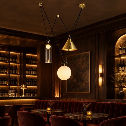 Kubik Geometric Modular Chandelier, Section F Gold Black White, in an intimate wine bar with dark wood and velvet seating