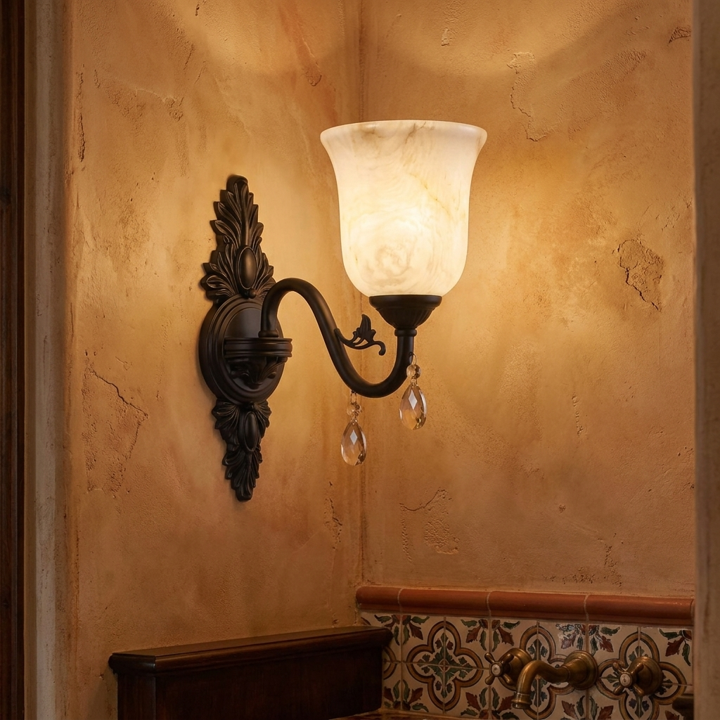 Clotilde matte black wall sconce on a plaster wall of a Spanish revival powder room