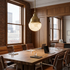 Gisele brass pendant light over a long conference table in a downtown office