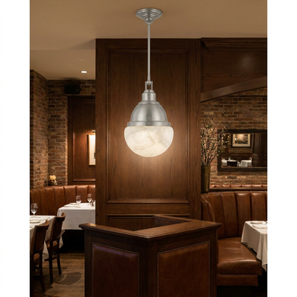 Gisele nickel pendant light over the host stand of an upscale bistro