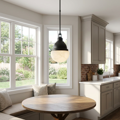 Gisele black pendant light above a breakfast nook in a sunlit suburban kitchen