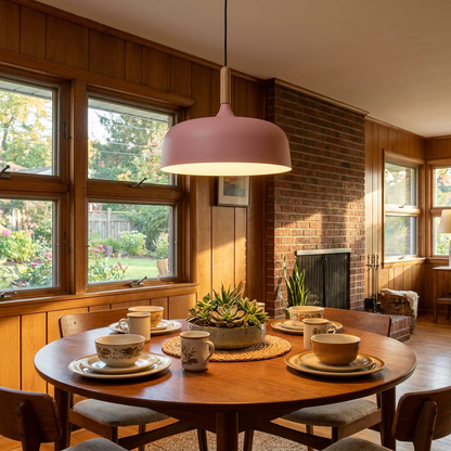Noisette pink pendant light above the dining table of a mid-century ranch home
