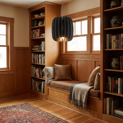 Lamelle oval graphite pendant light above a reading nook bench in a craftsman bungalow