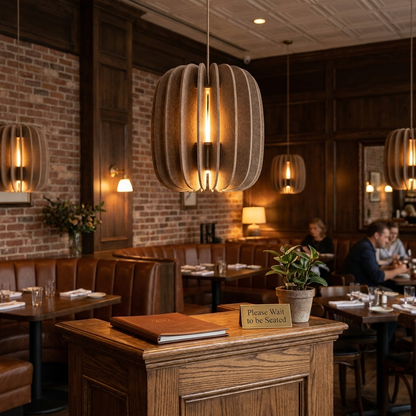 Lamelle oval brown pendant light over the host stand of an upscale bistro
