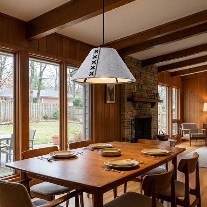 Feliciane light gray pendant light above the dining table of a mid-century ranch home