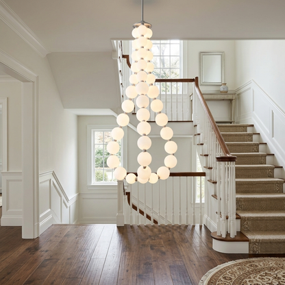 Nacre teardrop shaped pearl chandelier in a two story foyer of a colonial home
