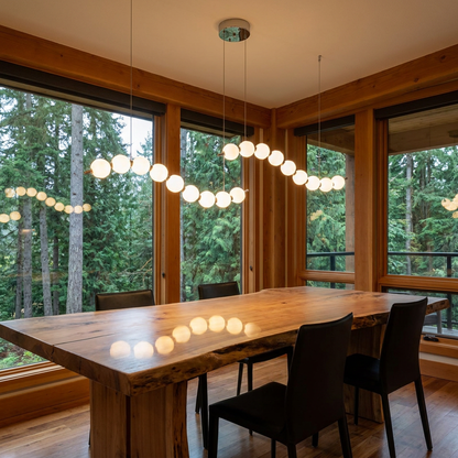 Nacre double strand linear pearl chandelier over a dining table in a Pacific Northwest home