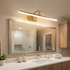 Cervo gold linear LED wall lamp above a bathroom mirror in a suburban home