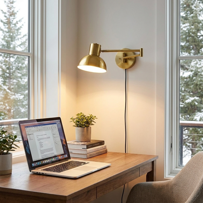 Swivo plug in swing arm wall lamp in brushed gold in a home office