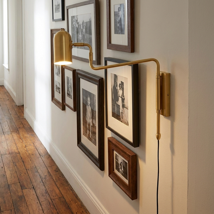 Swivo plug in swing arm wall lamp in brushed gold in a hallway of a Brooklyn apartment