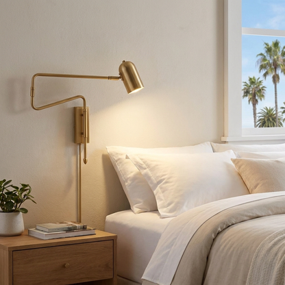 Arley hardwired swing arm reading wall lamp in brushed gold in a hotel guest room