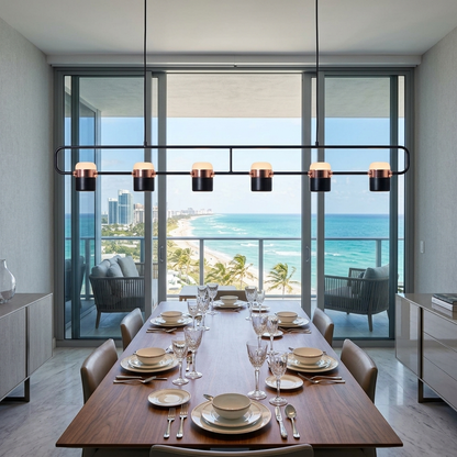 Marisol extra long linear LED pendant light over a dining table in a Miami condo