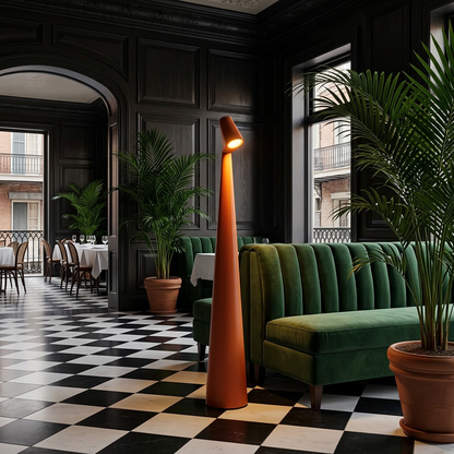 Yselle conical floor lamp in Orange beside a banquette in a restaurant lounge