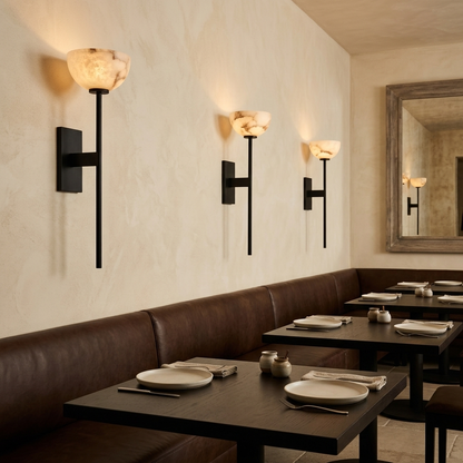 Caelan alabaster cup wall sconces in black above a banquette in an Austin restaurant