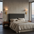 Caelan alabaster cup wall sconces in gold flanking a bed in a New York City apartment