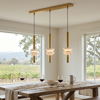 Brontee 3-light linear alabaster pendant in gold over a Napa farmhouse dining table