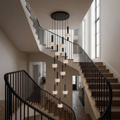 Brontee 11-head alabaster cluster pendant in black in a New York City townhouse stairwell