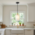 Carmeline Alabaster Cylinder Staircase Chandelier 1-light over the sink in a suburban white kitchen
