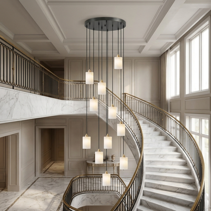Carmeline Alabaster Cylinder Staircase Chandelier 11-light in a hotel lobby with a curved staircase