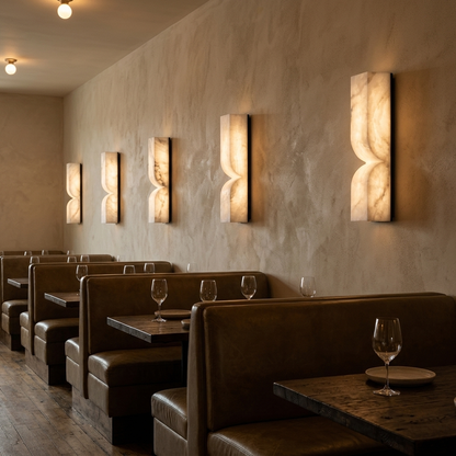 Chantal Solid Carved Alabaster LED Wall Sconce 13.8 in. in black above restaurant booths